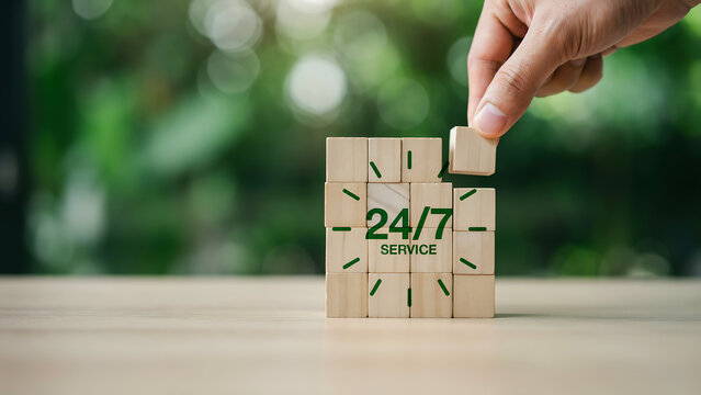 Hand placing block on 24/7 service wooden clock tower stack