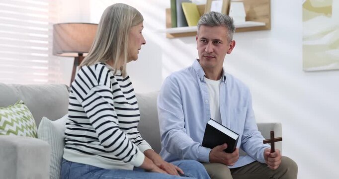 Pastor conducting Bible study with senior woman at home