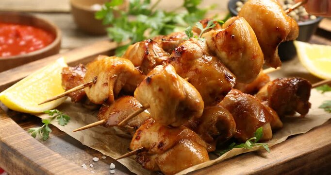 Man taking delicious shish kebabs at table, closeup