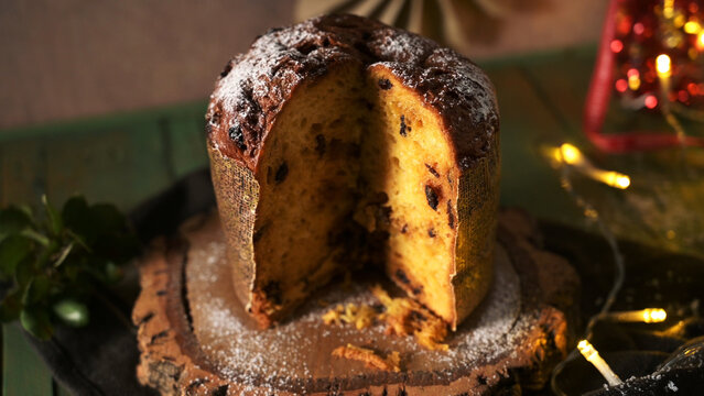 Festive Christmas panettone cake cut open on a wooden board