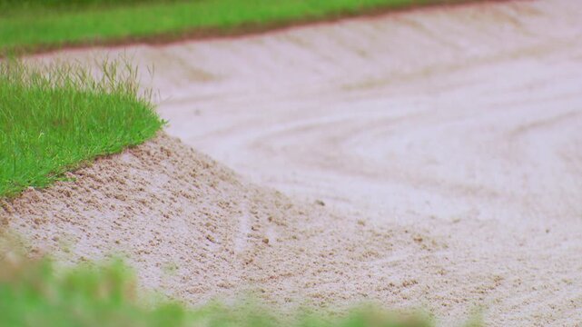 The background of the beautiful golf course sand traps is clearly visible in the foreground.