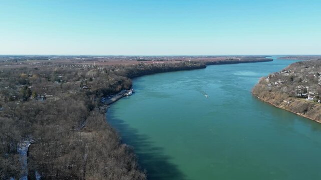 Aerial over the Niagara River to Lake Ontario during winter, March 2023. Border of the United States and Canada, Queenston, Ontario and Lewiston, New York. Flying forward, north.