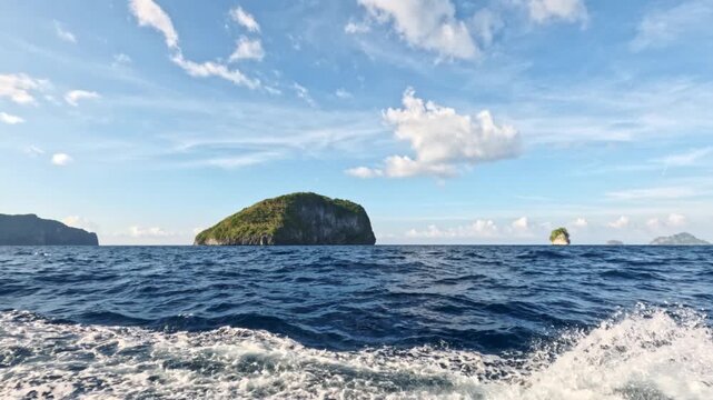 Tropical islands rise from the vibrant blue ocean, captured in a series of frames showcasing the serene beauty of the Philippine landscape