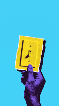 Hand holding ripped paper with yellow light switch against bright blue background