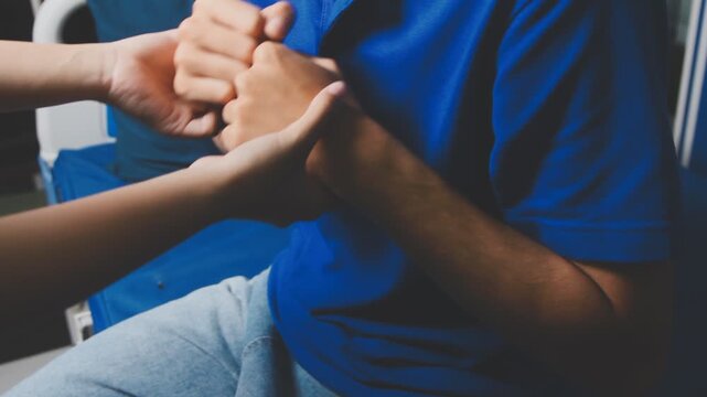 Doctor physiotherapist assisting a male patient while giving exercising treatment massaging the arm of patient in a physio room, rehabilitation physiotherapy concept