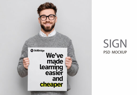 Smiling White Man Holding Sign Mockup PSD In A Studio Portrait