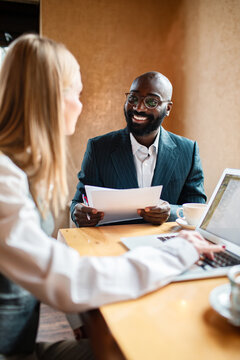 Smiling recruiter interviewing candidate at cafe