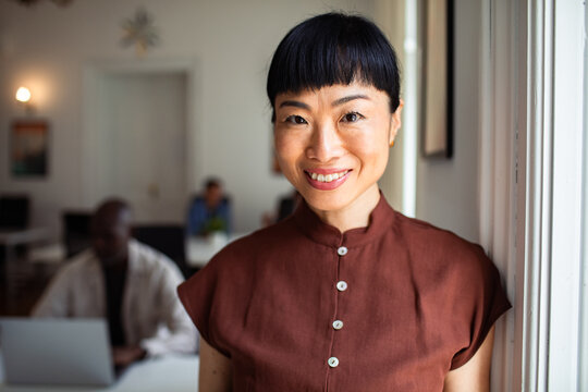 Portrait of smiling professional woman in modern coworking office