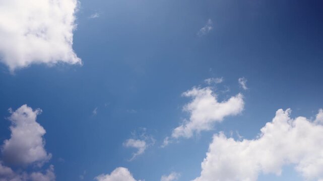 Sky timelapse showing white clouds moving across a blue sky, illustrating weather patterns, atmospheric movement and natural beauty for weather and environmental content.