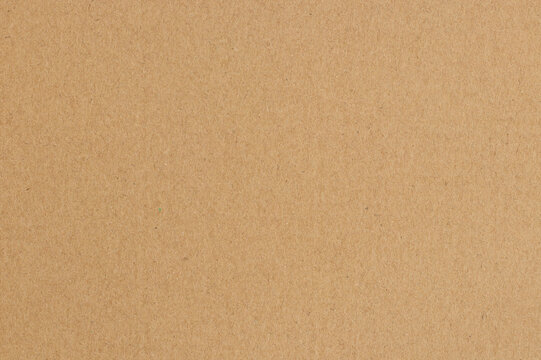 Brown cardboard sheet abstract background, texture of sepia color kraft paper with vintage pattern for design art work.