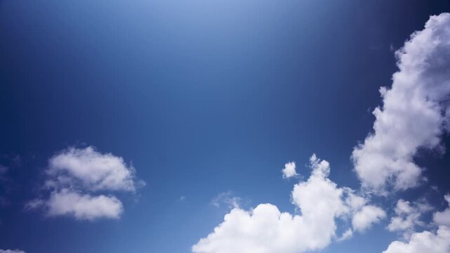 Sky timelapse showing white clouds moving across a blue sky, illustrating weather patterns, atmospheric movement and natural beauty for weather and environmental content.