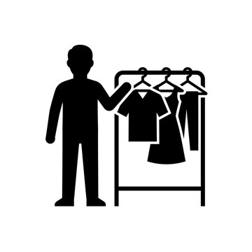 Man selecting clothes from wardrobe rack icon vector silhouette representation
