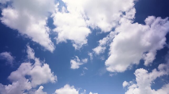 Sky timelapse showing white clouds moving across a blue sky, illustrating weather patterns, atmospheric movement and natural beauty for weather and environmental content.