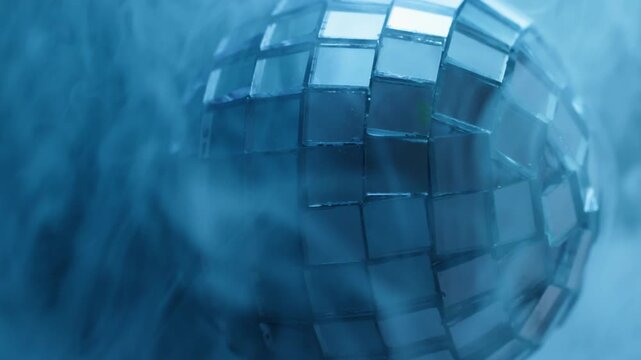 Vertical video. Glow disco ball. Blue haze. Blur color round texture cold splash fume broken glass water smoke on abstract light background.