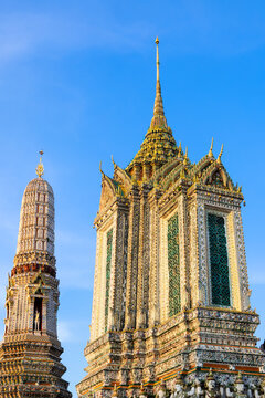 Wat Arun Buddhist temple spires against blue sky