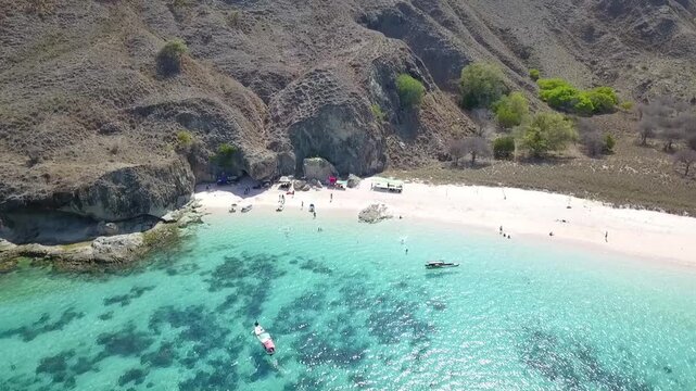 High aerial drone camera movement revealing the raw and pristine environment around Pink Beach in Komodo National Park.