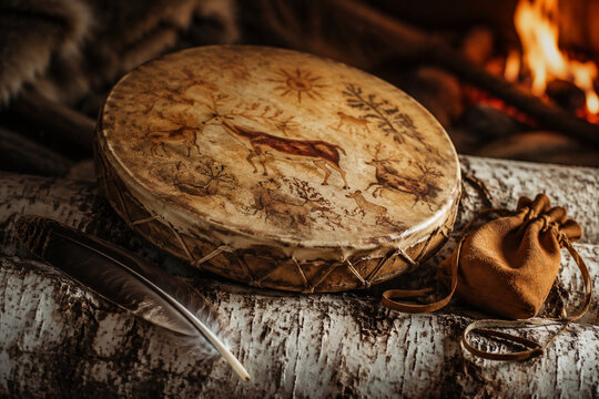 Shamanic frame drum with painted hide on birch log, spiritual and ritual tradition concept