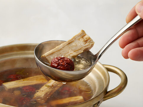 Steeping medicinal herbs, roots, and berries in a pot of hot water for natural remedy