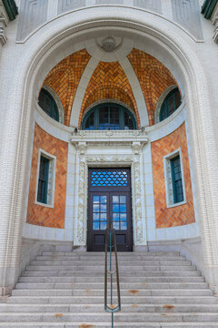 Ornate arched entrance with steps leading to building