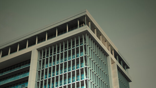 Contemporary Corporate Office Building Facade with Clean Vertical Lines and Minimalist Glass Louvers for Modern Business Architecture Real Estate and Urban Skyline Backdrop