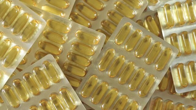 Close-up of omega-3 gel capsules arranged in blister packs, highlighting the glossy texture and orderly layout of the supplements