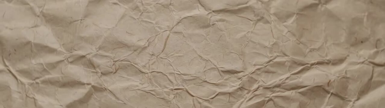 Sustainability and eco friendly packaging concept brown recycled paper texture with deep creases and folds organic material background.