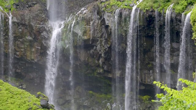 Beautiful detailed close up shot over water falling from rocky cliffs