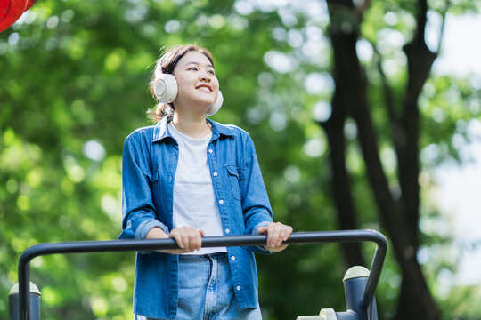 Young woman enjoying outdoor exercise listening music