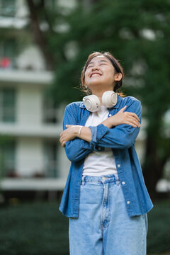 Asian woman embracing self love and happiness outdoors