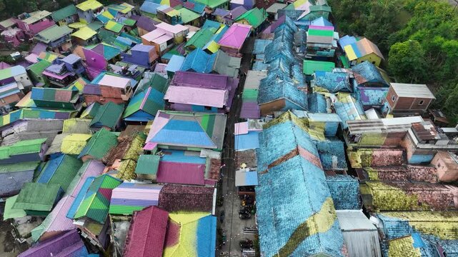 Brightly Painted Rainbow Village Of Kampung Warna-Warni Jodipan, Along The Brantas River In Malang, East Java, Indonesia. - aerial shot