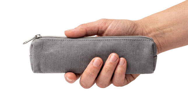 Grey canvas pencil case held in hand, minimalist fabric stationery pouch, portable textile zipper bag for school and office supplies isolated PNG with Transparent Background