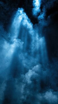 God rays break through the mist in a dark area, creating a cool atmosphere and open space, allowing for graphic overlays or text addition.