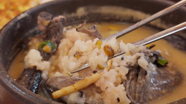 Korean Black Chicken Samgyetang Chopsticks Lifting Glutinous Rice Inside Chicken
