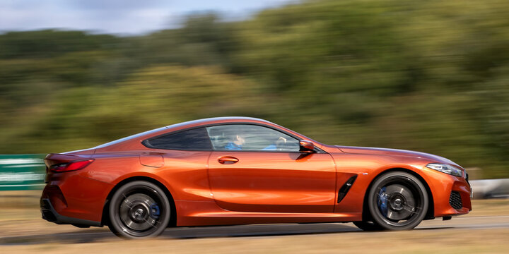 Milton Keynes; UK - Aug 30th 2026: 2019 orange BMW 8 series 840D diesel engine car driving on a British road