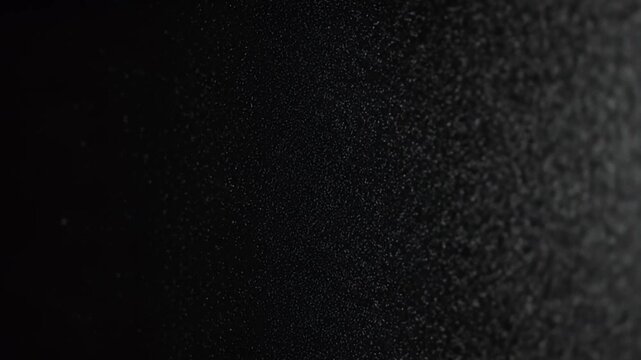 Abstract close-up macro textured background with dark granular fading into black