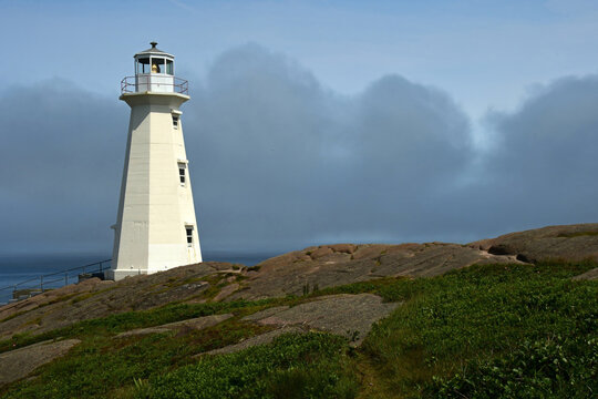 the cape spear lighthouse  on a rocky bluff  in  the cape spear lighthouse national historic site in summer  in cape spear, newfoundland, canada