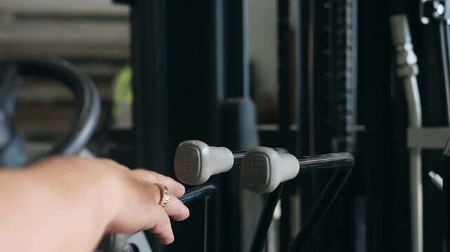 Close-up of operator using a forklift control lever to activate the hydraulic lifting mechanism as the mast and chains move upward during warehouse operation.