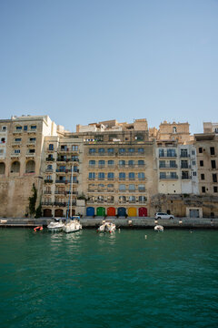 Colorful boathouses along a sunny Malta waterfront