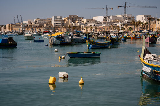 Colorful fishing boats in a sunny Maltese harbor