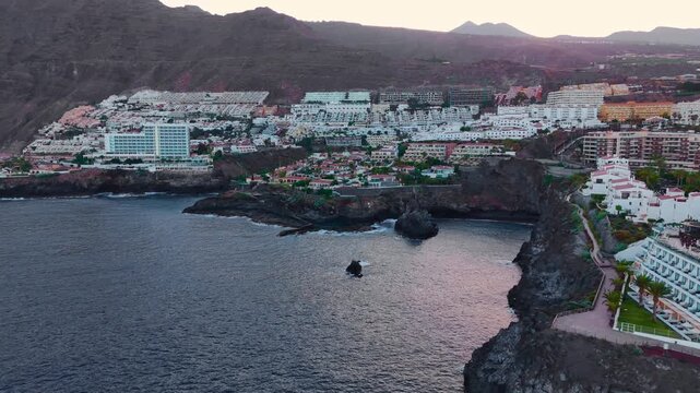 Aerial view of a coastal city and the ocean, Atlantic Ocean, Tenerife: view of the town and the Los Gigantes cliffs and Masca Mountains.