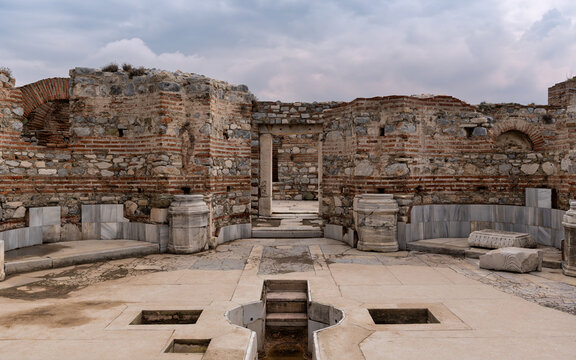 Ancient stone walls and a baptismal font within the historic ruins of the Basilica of St. John in Selcuk, Izmir, Turkey