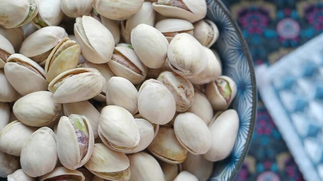 Pistachios in a bowl on a colorful tablecloth