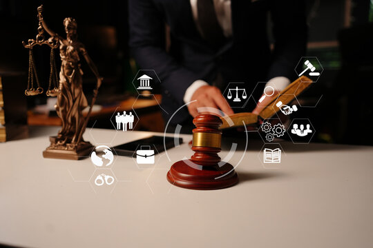 Lawyer working with law book and digital legal tech icons in office