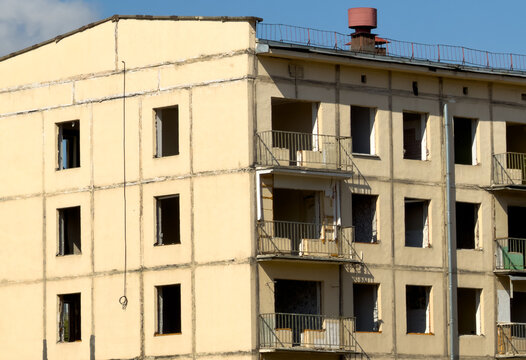 Abandoned apartment building with broken windows