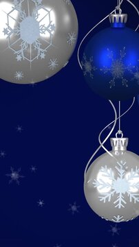 Animation of baubles and snow falling on dark blue background