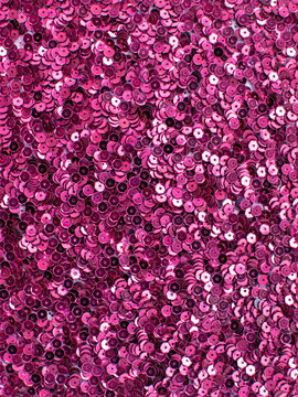 Bright magenta sequin fabric texture background