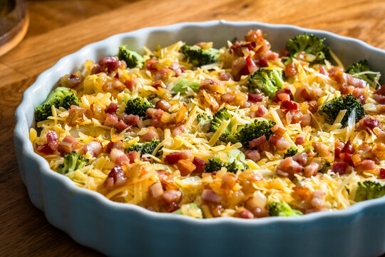 Uncooked potato broccoli casserole - potatoes with broccoli, cheddar cheese and smoked bacon ready to cook