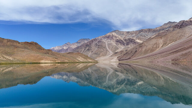 Cinematic Drone View of Chandratal Lake Near Spiti Valley, Himachal Pradesh with Turquoise Mountain Water, Rocky Slopes and Majestic High Altitude Himalayan Scenery
