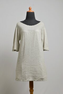 Light gray sweater dress with boat or Sabrina neckline on a dress form