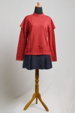 Red ruffle long sleeves sweater with mini skirt on a mannequin display
